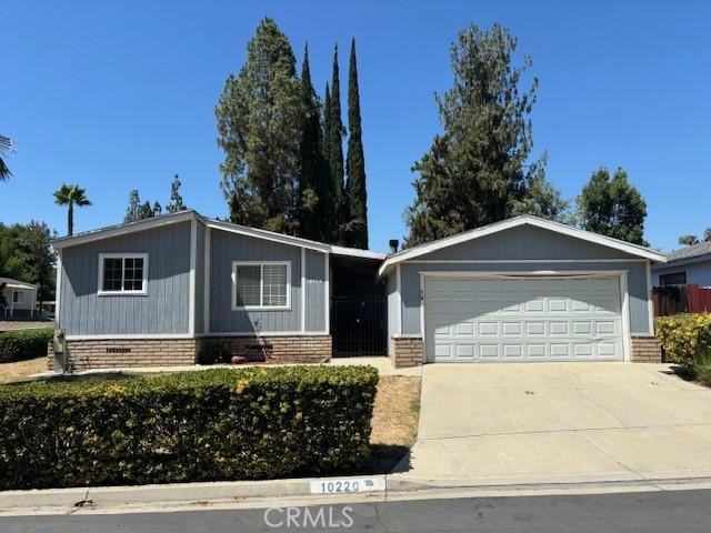 10220 Wrangler Way, Corona, CA 92883 - view of front of house featuring concrete driveway and an attached garage
