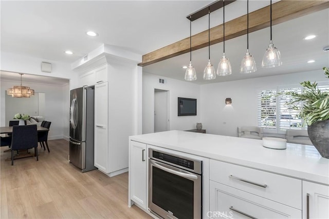 22608 Crespi St, Woodland Hills, CA 91364 - kitchen featuring appliances with stainless steel finishes, light wood-style flooring, white cabinetry, a chandelier, and recessed lighting
