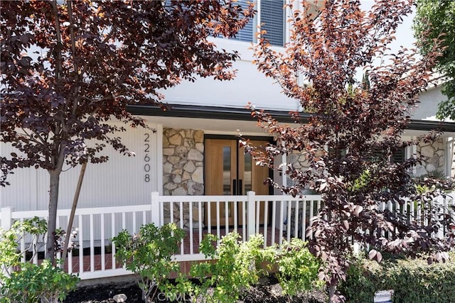 22608 Crespi St, Woodland Hills, CA 91364 - view of exterior entry featuring covered porch and stone siding