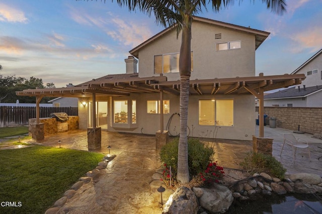 1531 Daphne Ave, Ventura, CA 93004 - back of house at dusk with stucco siding, a fenced backyard, a patio area, and a pergola