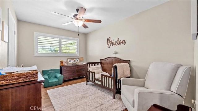 1052 Golden Rain St, Upland, CA 91786 - bedroom with wood finished floors, a nursery area, and a ceiling fan