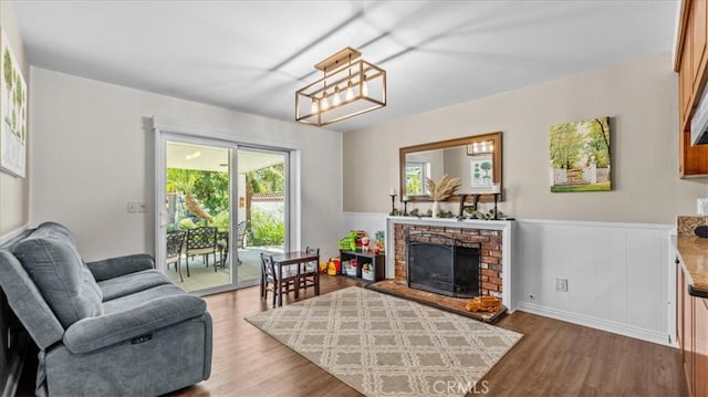 1052 Golden Rain St, Upland, CA 91786 - living room featuring wood finished floors, a fireplace, and a wainscoted wall