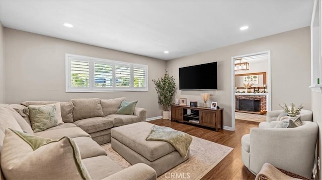1052 Golden Rain St, Upland, CA 91786 - living area with wood finished floors, recessed lighting, and a brick fireplace