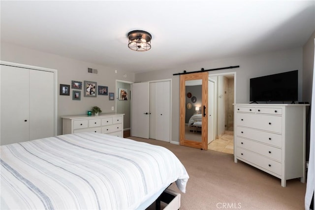 348 Clubhouse Dr, Santa Maria, CA 93455 - bedroom with multiple closets, a barn door, and light colored carpet