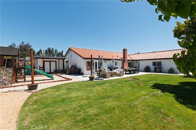 348 Clubhouse Dr, Santa Maria, CA 93455 - rear view of property with a playground, an outdoor living space, a lawn, and stucco siding
