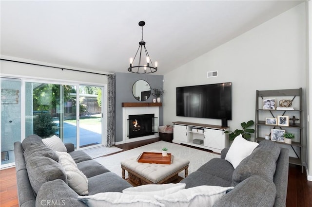 348 Clubhouse Dr, Santa Maria, CA 93455 - living room featuring a chandelier, wood finished floors, a lit fireplace, and high vaulted ceiling
