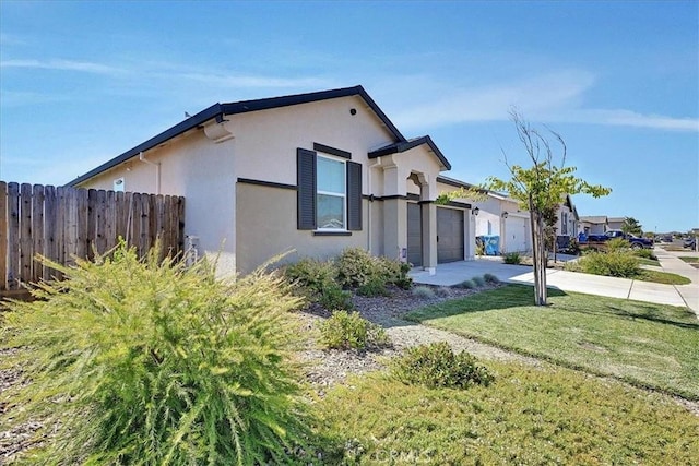 5516 Sunhaven St, Marysville, CA 95901 - view of property exterior featuring stucco siding, an attached garage, and concrete driveway