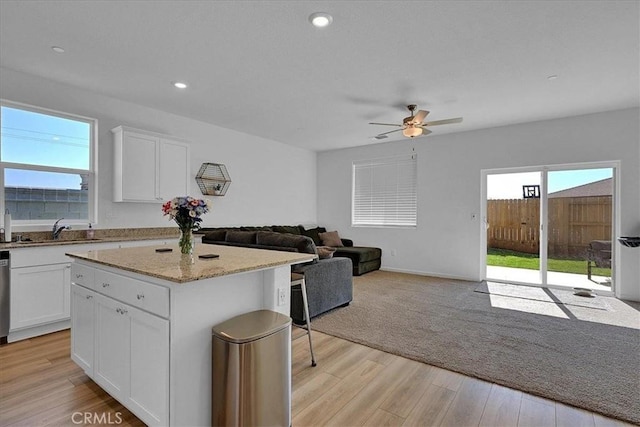 5516 Sunhaven St, Marysville, CA 95901 - kitchen featuring open floor plan, a ceiling fan, white cabinetry, a kitchen island, and recessed lighting