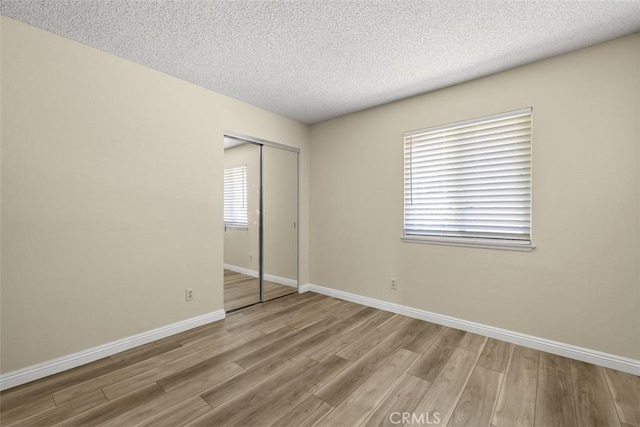 3262 Avenida Simi, Simi Valley, CA 93063 - unfurnished bedroom featuring wood finished floors, a closet, and a textured ceiling