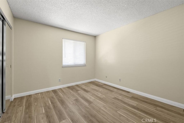 3262 Avenida Simi, Simi Valley, CA 93063 - unfurnished bedroom with wood finished floors, a closet, and a textured ceiling