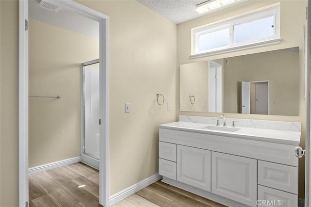 3262 Avenida Simi, Simi Valley, CA 93063 - full bath with vanity, wood finished floors, a shower stall, and a textured ceiling