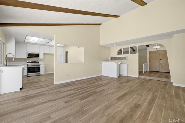 3262 Avenida Simi, Simi Valley, CA 93063 - unfurnished living room featuring beamed ceiling, light wood finished floors, arched walkways, radiator, and high vaulted ceiling