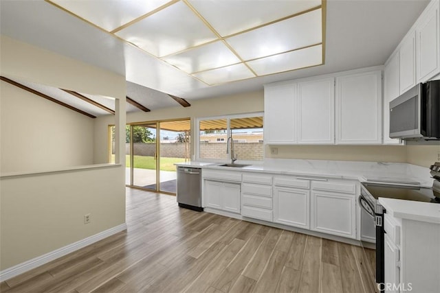 3262 Avenida Simi, Simi Valley, CA 93063 - kitchen with appliances with stainless steel finishes, white cabinets, light countertops, light wood-style flooring, and vaulted ceiling