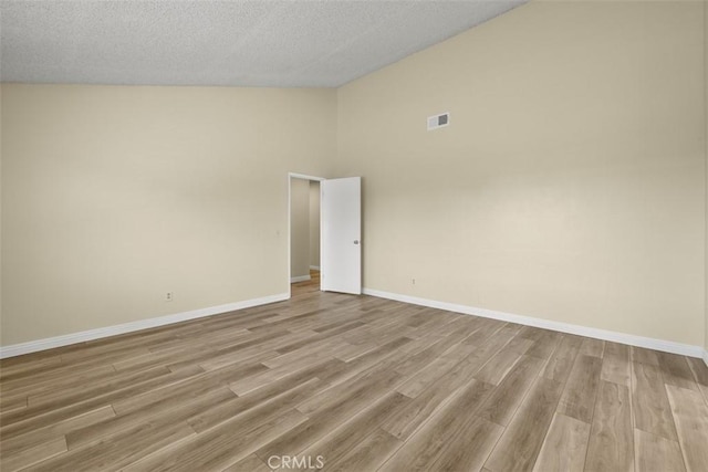 3262 Avenida Simi, Simi Valley, CA 93063 - spare room featuring light wood finished floors, a textured ceiling, and high vaulted ceiling