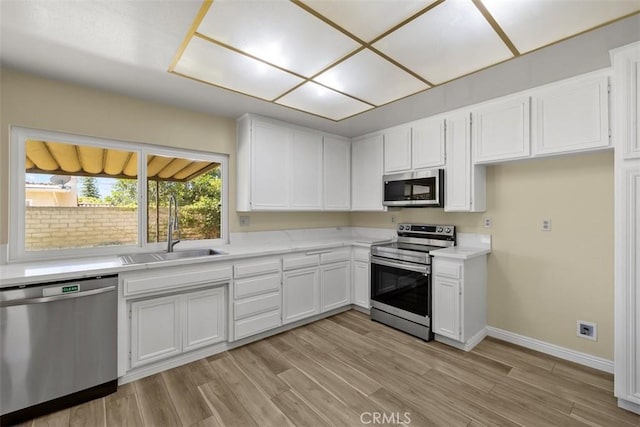 3262 Avenida Simi, Simi Valley, CA 93063 - kitchen featuring stainless steel appliances, light countertops, white cabinetry, and light wood-style flooring