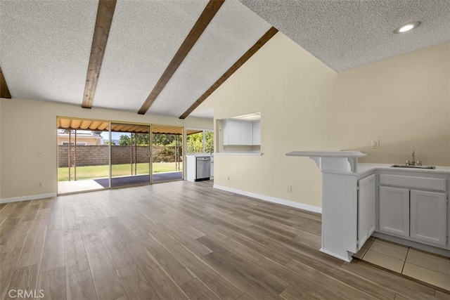 3262 Avenida Simi, Simi Valley, CA 93063 - unfurnished living room with beamed ceiling, wood finished floors, a textured ceiling, high vaulted ceiling, and bar with sink