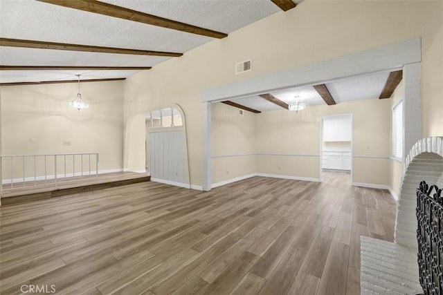3262 Avenida Simi, Simi Valley, CA 93063 - unfurnished living room with beam ceiling, wood finished floors, plenty of natural light, a chandelier, and a textured ceiling