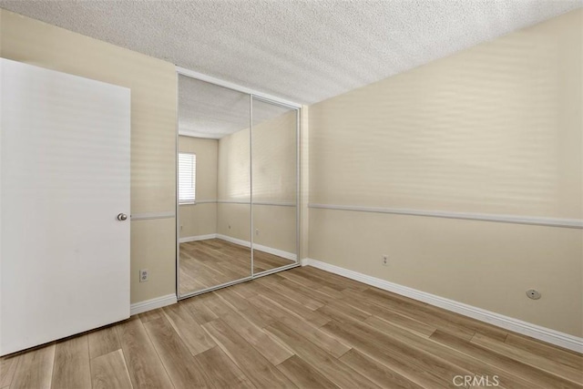 3262 Avenida Simi, Simi Valley, CA 93063 - unfurnished bedroom with a textured ceiling, wood finished floors, and a closet