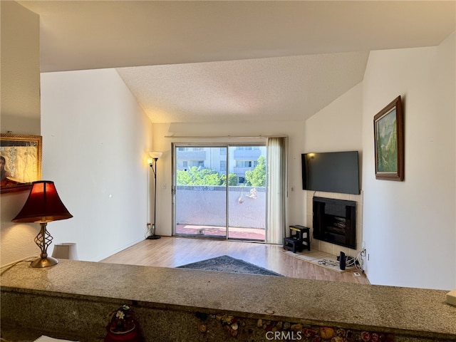 7640 Oso Ave Unit 316, Winnetka, CA 91306 - living room with wood finished floors and a tiled fireplace