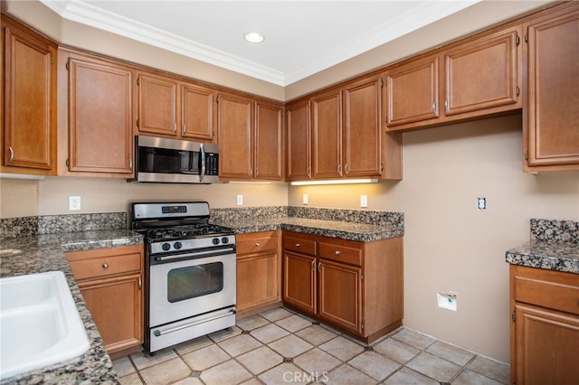 31241 Casera Ct, Menifee, CA 92584 - kitchen with stainless steel appliances, brown cabinetry, ornamental molding, recessed lighting, and light tile patterned flooring