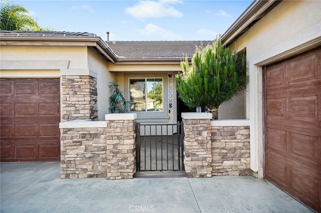 31241 Casera Ct, Menifee, CA 92584 - entrance to property with stucco siding, stone siding, concrete driveway, a gate, and an attached garage