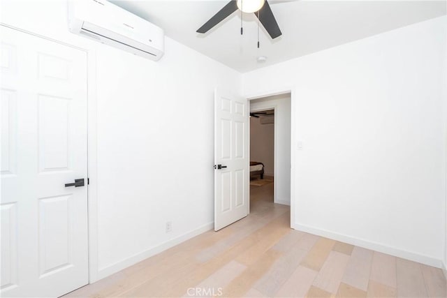 8168 Summerfield Ave, Whittier, CA 90606 - unfurnished bedroom with a wall mounted AC, light wood-type flooring, and ceiling fan
