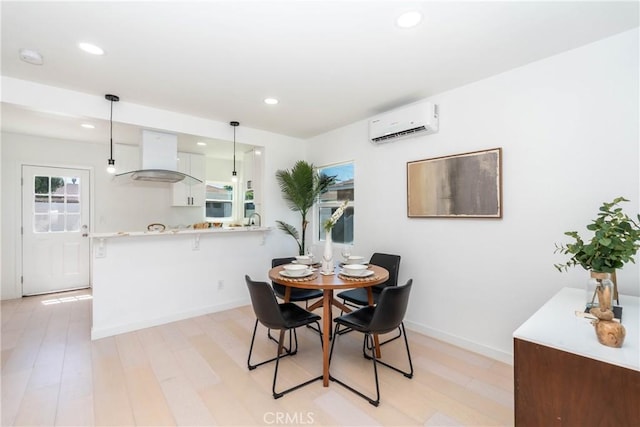 8168 Summerfield Ave, Whittier, CA 90606 - dining space featuring an AC wall unit, light wood-type flooring, and recessed lighting