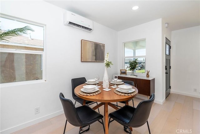 8168 Summerfield Ave, Whittier, CA 90606 - dining area featuring an AC wall unit, light wood finished floors, and recessed lighting