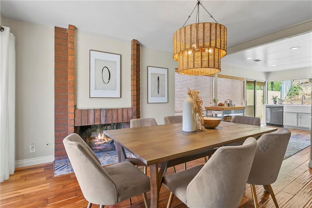 26551 Fresno Dr, Mission Viejo, CA 92691 - dining area with light wood finished floors, a chandelier, recessed lighting, and a fireplace