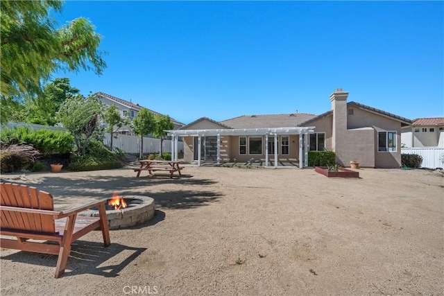 42730 Settlers Rdg, Murrieta, CA 92562 - rear view of property featuring an outdoor fire pit, a pergola, a patio area, a chimney, and stucco siding