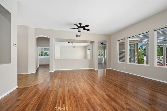 42730 Settlers Rdg, Murrieta, CA 92562 - unfurnished living room featuring ceiling fan, wood finished floors, and arched walkways