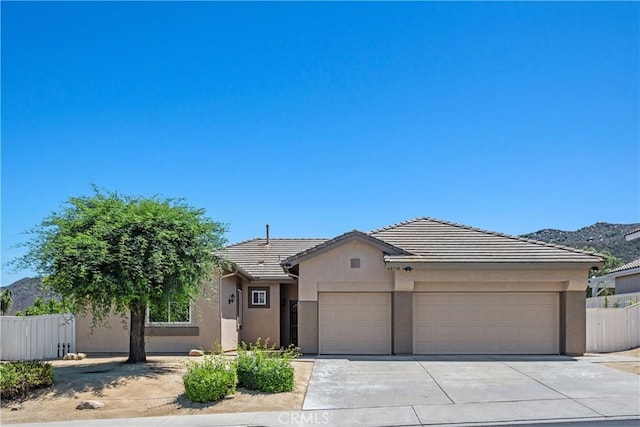 42730 Settlers Rdg, Murrieta, CA 92562 - view of front facade featuring stucco siding, an attached garage, a tile roof, and concrete driveway