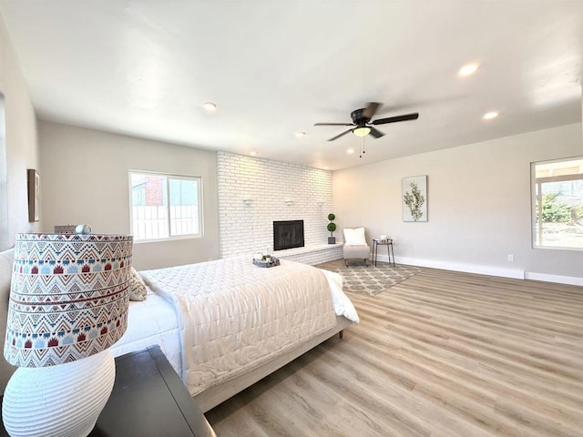 9944 Donner St, Santee, CA 92071 - bedroom with wood finished floors, multiple windows, recessed lighting, a brick fireplace, and ceiling fan