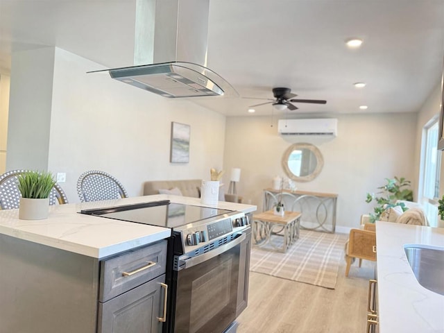9944 Donner St, Santee, CA 92071 - kitchen with stainless steel range with electric cooktop, a wall unit AC, island range hood, gray cabinets, and light stone countertops