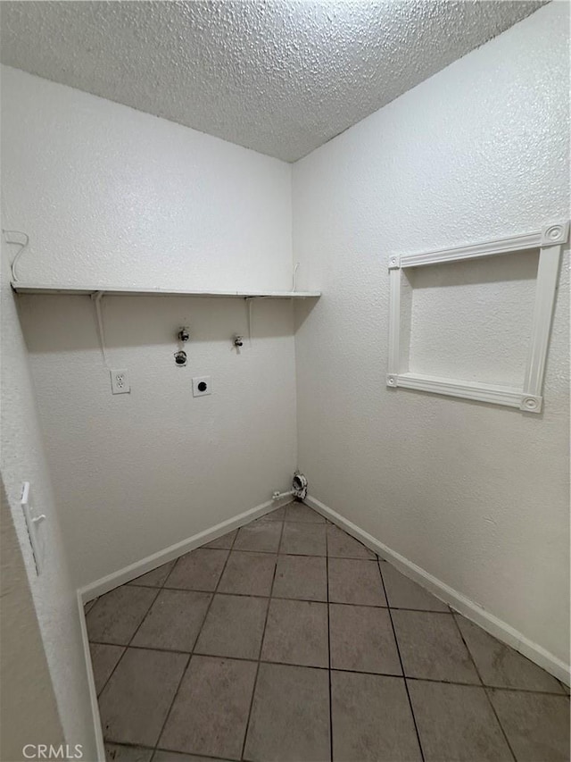 1032 W Coronado Ave, Ridgecrest, CA 93555 - laundry room featuring hookup for an electric dryer, tile patterned floors, a textured ceiling, and hookup for a gas dryer