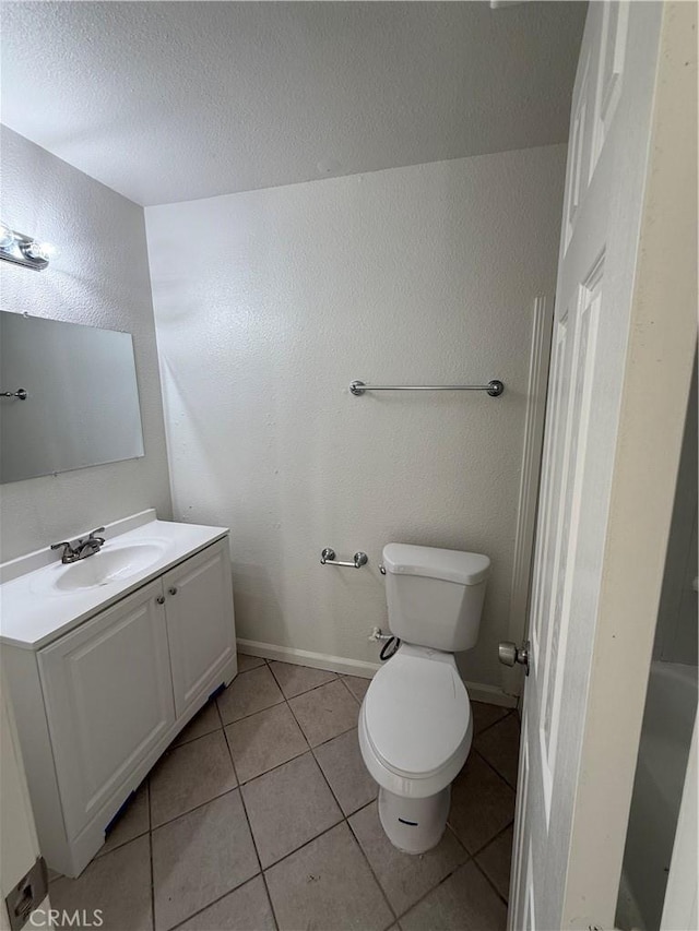 1032 W Coronado Ave, Ridgecrest, CA 93555 - bathroom featuring vanity, a textured ceiling, tile patterned floors, and a textured wall