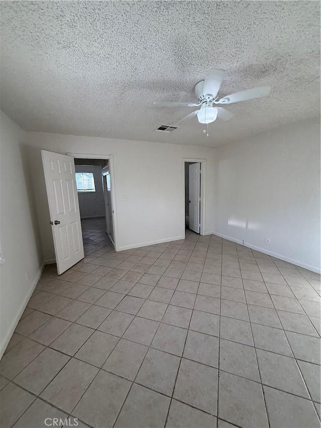 1032 W Coronado Ave, Ridgecrest, CA 93555 - empty room featuring light tile patterned flooring, a ceiling fan, and a textured ceiling