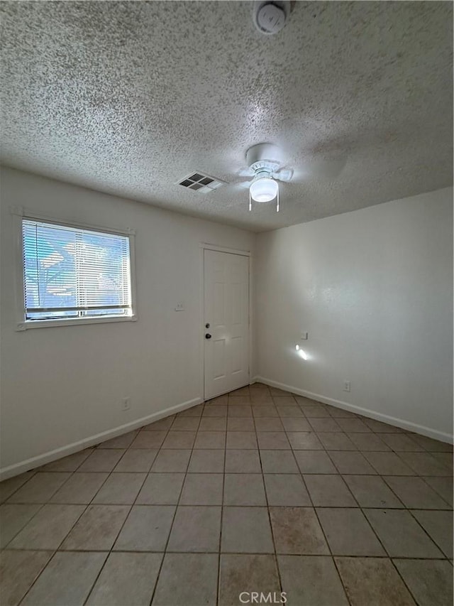 1032 W Coronado Ave, Ridgecrest, CA 93555 - empty room featuring a ceiling fan, a smoke detector, a textured ceiling, and light tile patterned flooring