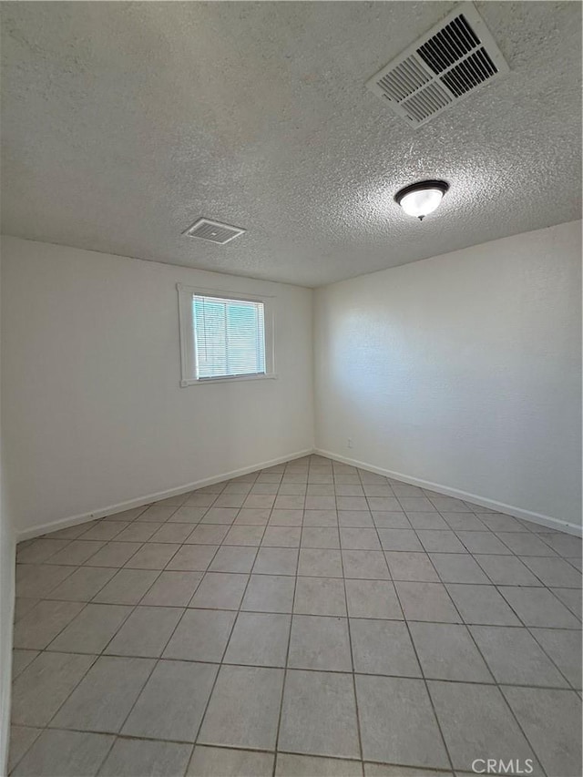 1032 W Coronado Ave, Ridgecrest, CA 93555 - empty room featuring a textured ceiling and light tile patterned floors