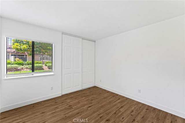 25632 Seaside Dr Unit 140, Dana Point, CA 92629 - unfurnished bedroom featuring wood finished floors and a closet