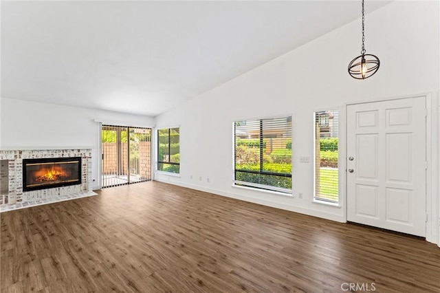 25632 Seaside Dr Unit 140, Dana Point, CA 92629 - unfurnished living room with dark wood-style floors, high vaulted ceiling, and a fireplace with flush hearth