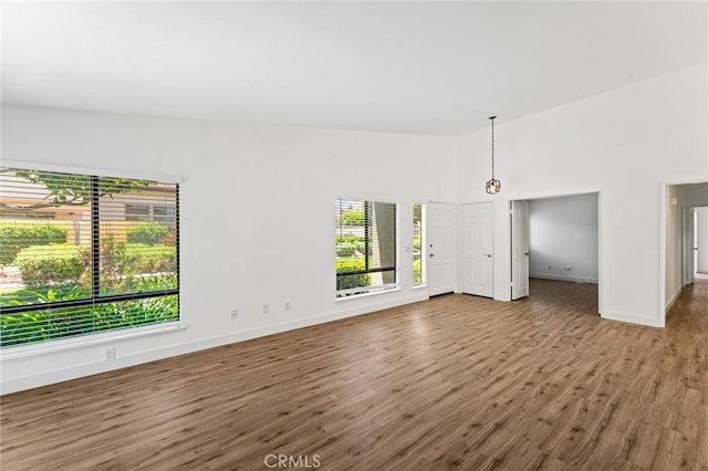 25632 Seaside Dr Unit 140, Dana Point, CA 92629 - unfurnished living room with baseboards and wood finished floors