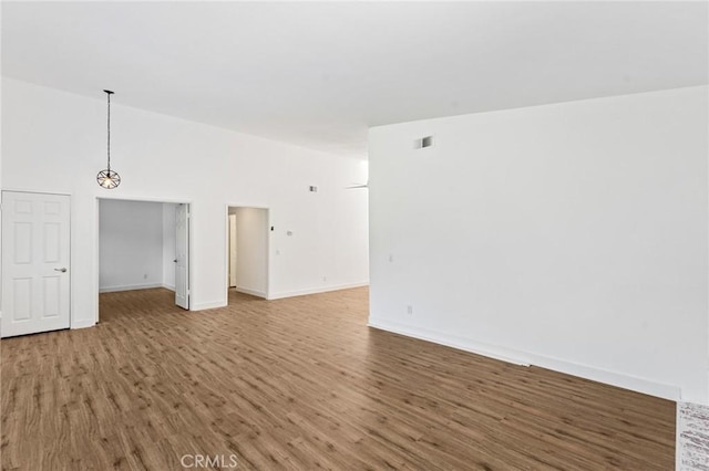 25632 Seaside Dr Unit 140, Dana Point, CA 92629 - unfurnished room with wood finished floors and vaulted ceiling