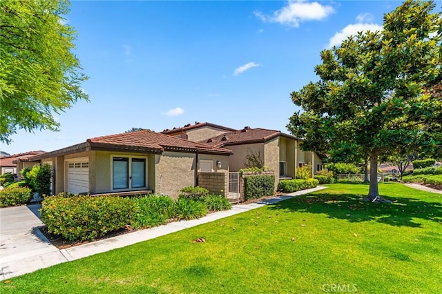 25632 Seaside Dr Unit 140, Dana Point, CA 92629 - mediterranean / spanish-style home featuring a garage, stucco siding, a tiled roof, and driveway