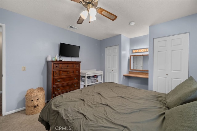 7420 London Ave, Rancho Cucamonga, CA 91730 - bedroom with multiple closets, carpet floors, ceiling fan, and a textured ceiling