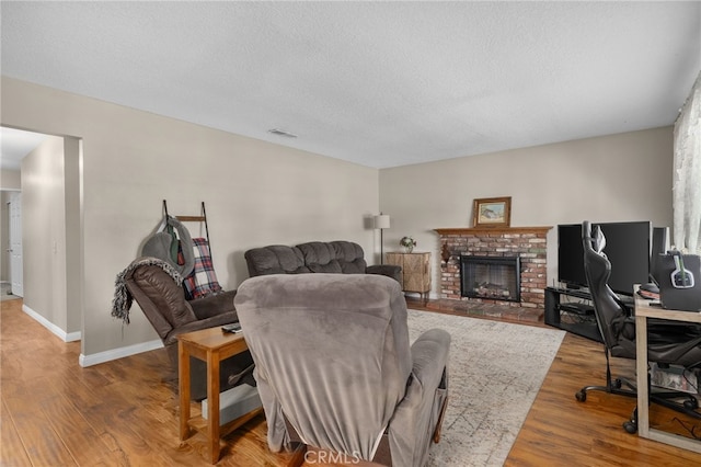 7420 London Ave, Rancho Cucamonga, CA 91730 - living area with wood finished floors, a fireplace, a textured ceiling, and an office area