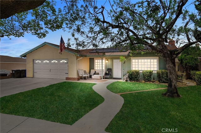 7420 London Ave, Rancho Cucamonga, CA 91730 - single story home with a garage, an outdoor hangout area, a front lawn, stucco siding, and concrete driveway