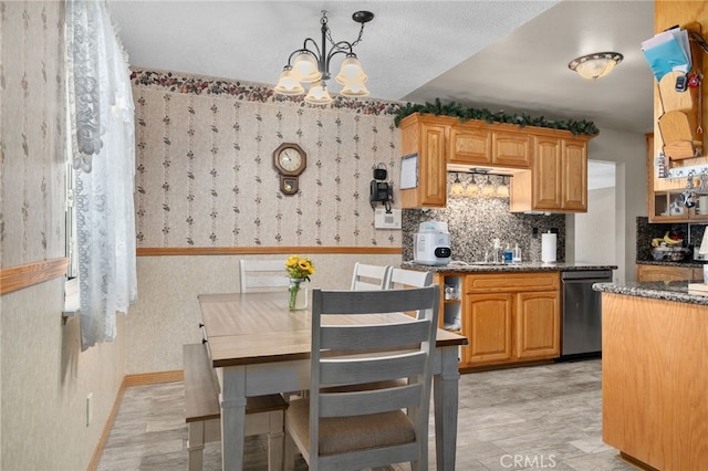 7420 London Ave, Rancho Cucamonga, CA 91730 - kitchen featuring stainless steel dishwasher, a chandelier, wallpapered walls, decorative backsplash, and light wood finished floors