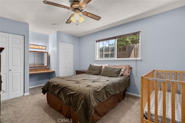 7420 London Ave, Rancho Cucamonga, CA 91730 - carpeted bedroom with multiple closets, a textured ceiling, and a ceiling fan
