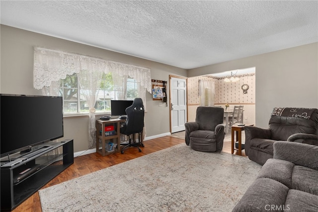 7420 London Ave, Rancho Cucamonga, CA 91730 - living area with wood finished floors, a textured ceiling, and an office area